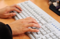Woman typing on a computer keyboard